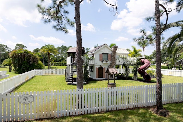 view of front of home featuring a playground and a front yard