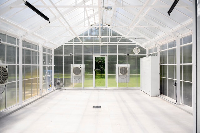 unfurnished sunroom featuring lofted ceiling, ac unit, and a wealth of natural light