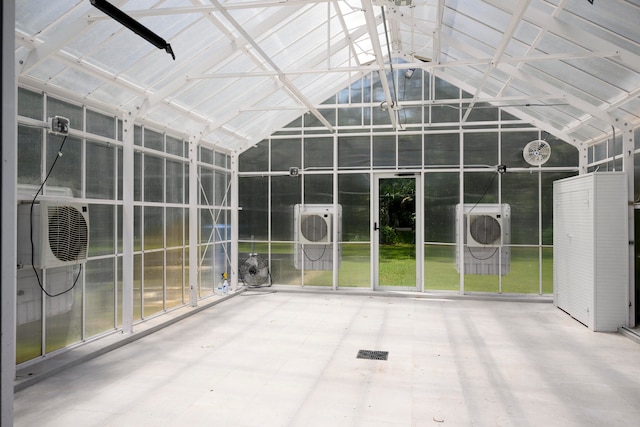 unfurnished sunroom featuring ac unit and vaulted ceiling