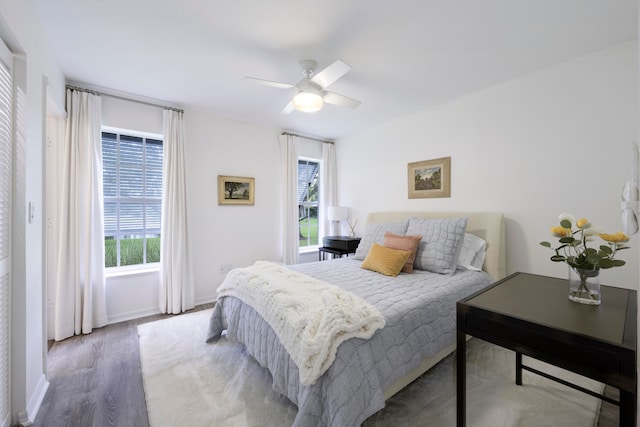 bedroom with light hardwood / wood-style flooring and ceiling fan