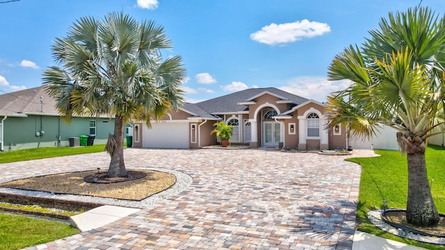 view of front of house featuring a front yard and a garage