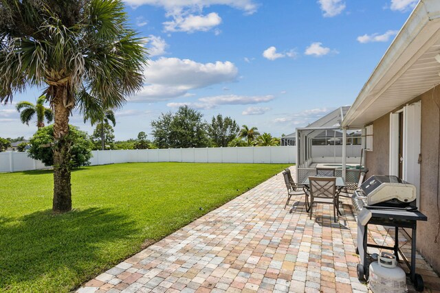 view of patio / terrace featuring glass enclosure