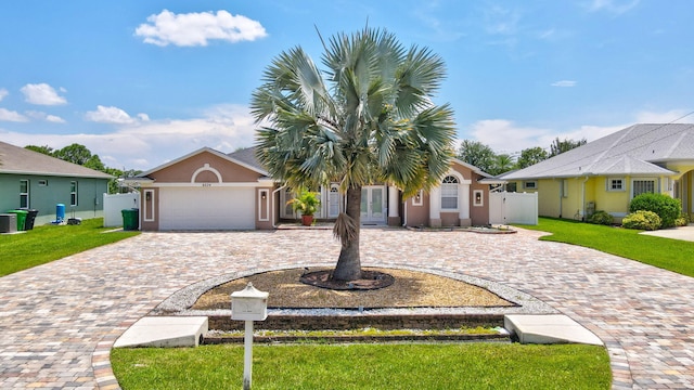 view of front of house featuring a garage and a front lawn