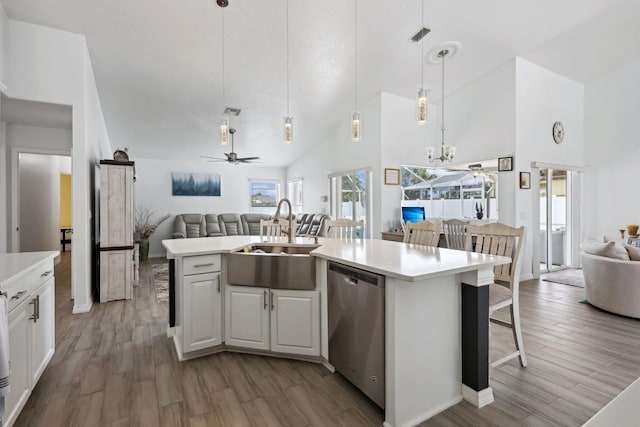 kitchen with dishwasher, decorative light fixtures, sink, light wood-type flooring, and ceiling fan with notable chandelier