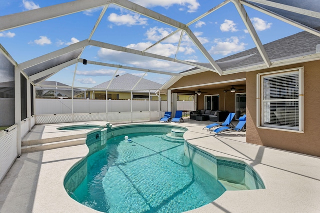 view of pool with ceiling fan, glass enclosure, an in ground hot tub, and a patio