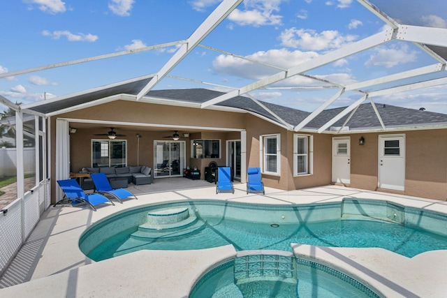 view of swimming pool featuring glass enclosure, a patio area, an in ground hot tub, and ceiling fan