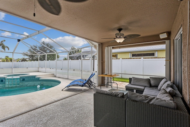 view of swimming pool with ceiling fan, a lanai, an in ground hot tub, an outdoor living space, and a patio area