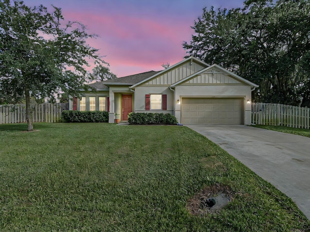 view of front of home with a lawn and a garage