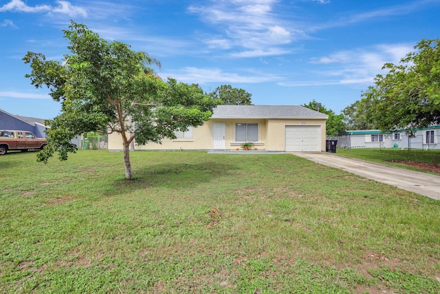 ranch-style house featuring a front lawn and a garage