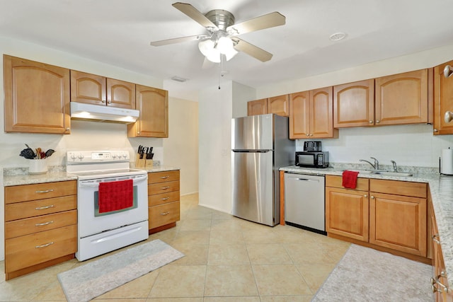 kitchen with stainless steel appliances, sink, ceiling fan, light stone counters, and light tile patterned flooring