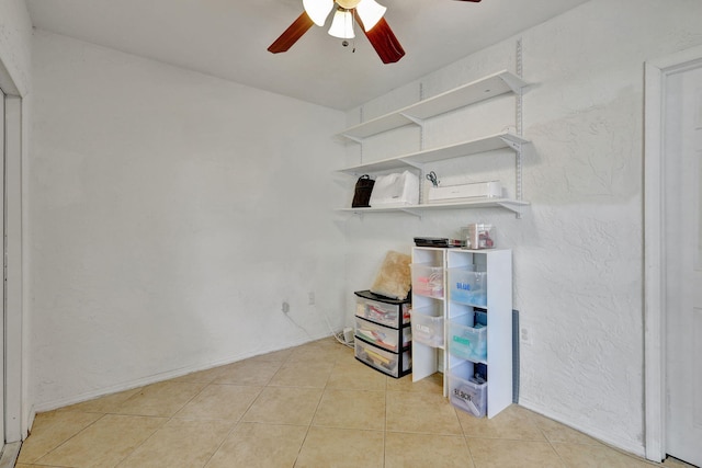 interior space with ceiling fan