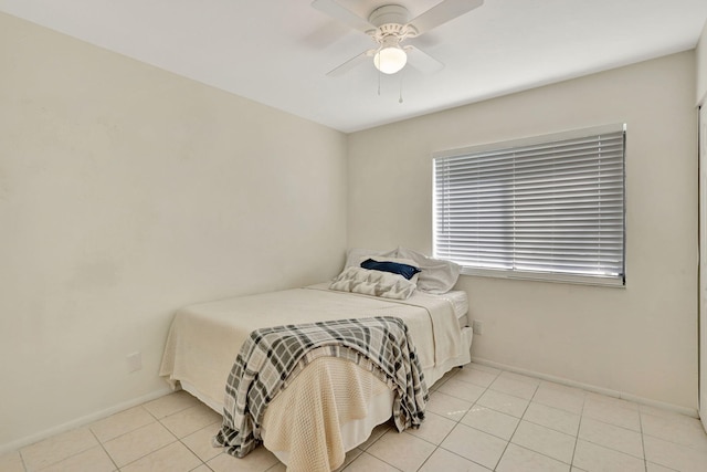 tiled bedroom featuring ceiling fan