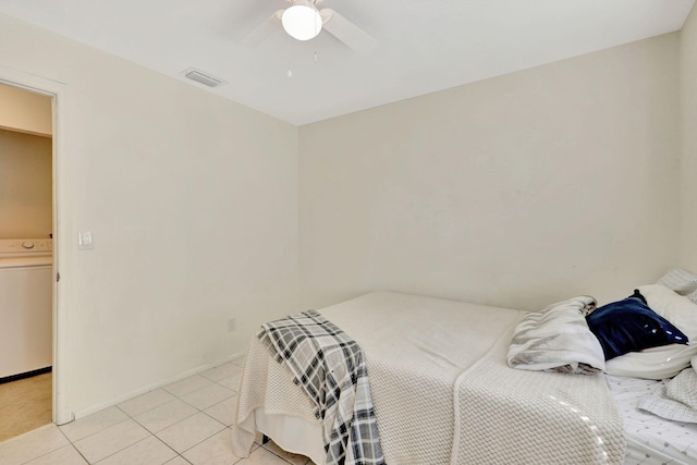 tiled bedroom with washer / clothes dryer and ceiling fan