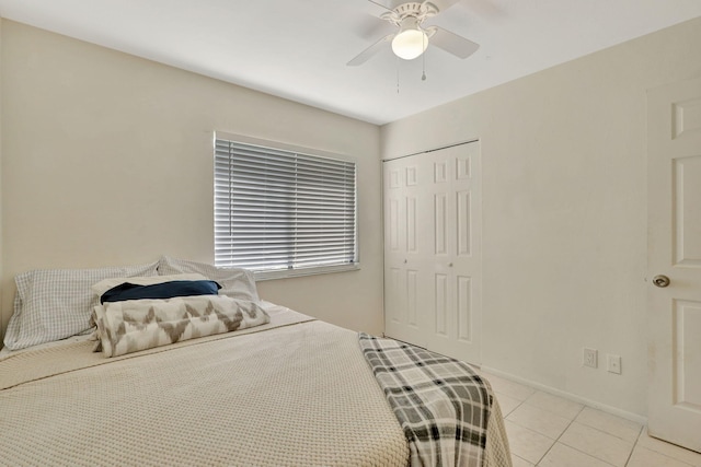 tiled bedroom featuring a closet and ceiling fan