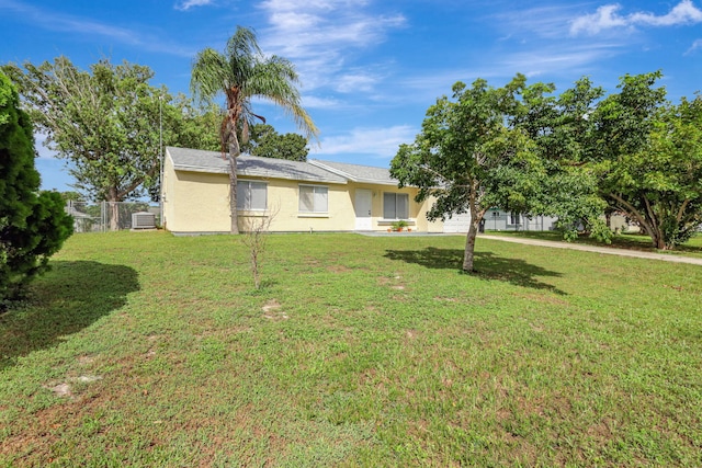 exterior space with cooling unit and a front yard