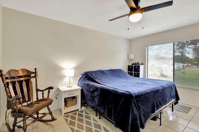 tiled bedroom featuring ceiling fan