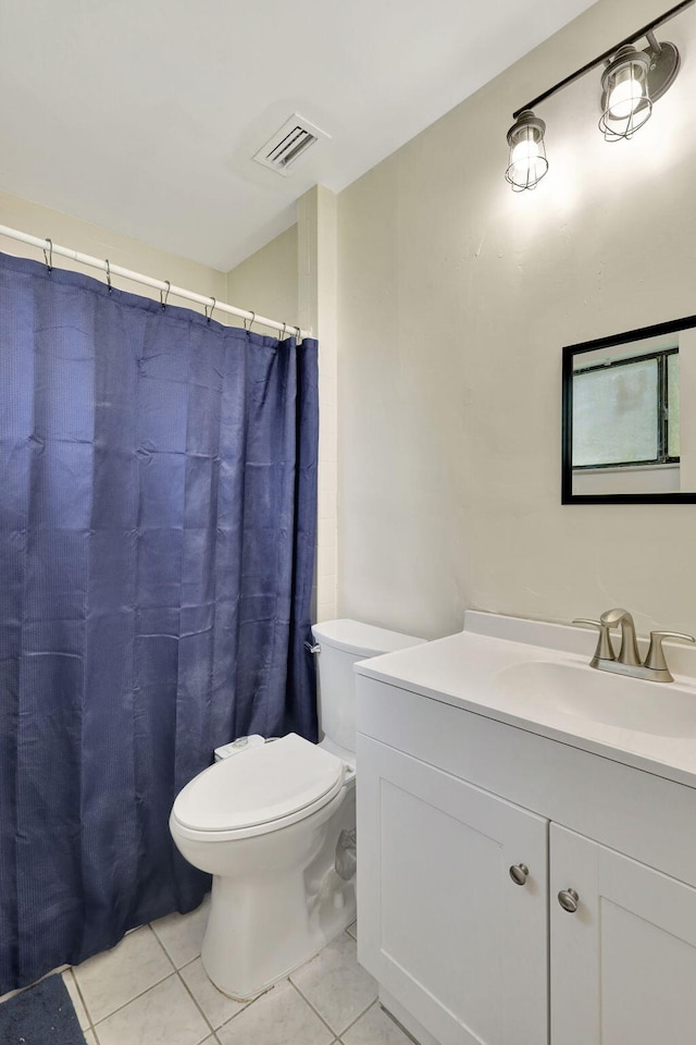 bathroom with tile patterned flooring, toilet, and vanity