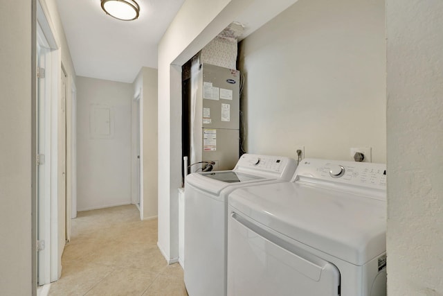 laundry area with separate washer and dryer, heating unit, and light tile patterned flooring