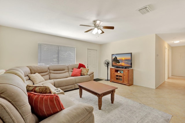 tiled living room with ceiling fan