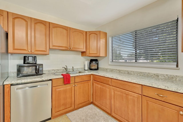 kitchen featuring light tile patterned floors, dishwasher, a wealth of natural light, and sink