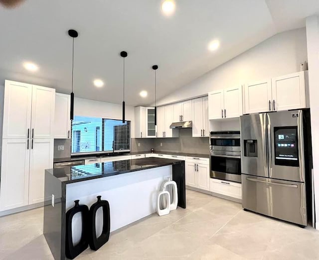 kitchen with white cabinetry, a center island, stainless steel appliances, and lofted ceiling