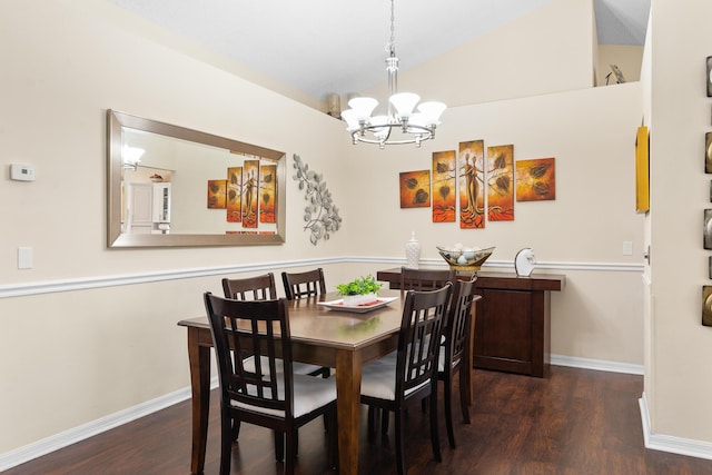 dining space featuring dark wood-type flooring, a chandelier, and vaulted ceiling