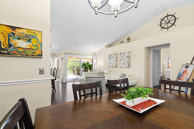 dining space with hardwood / wood-style flooring, vaulted ceiling, and a notable chandelier