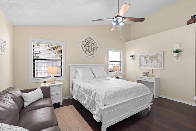 bedroom featuring lofted ceiling, a textured ceiling, multiple windows, and ceiling fan