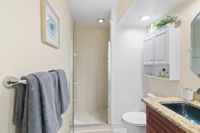 bathroom with walk in shower, vanity, and toilet