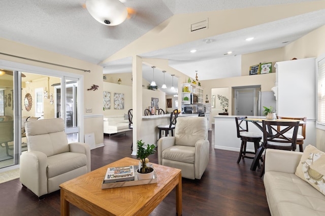 living room featuring lofted ceiling, dark hardwood / wood-style floors, and a textured ceiling