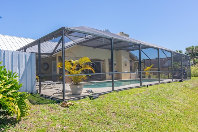 back of house with a yard, a lanai, and a patio area