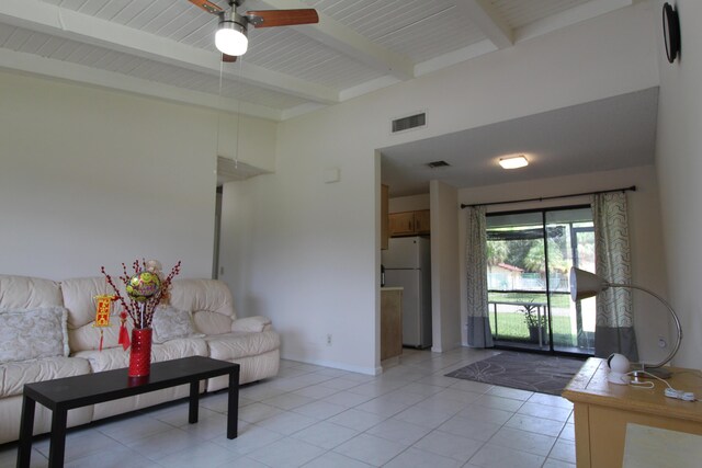 living room featuring wood ceiling, ceiling fan, light tile patterned floors, and beamed ceiling