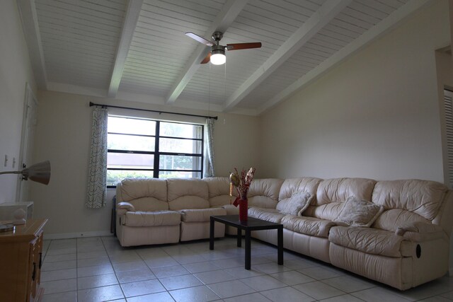 tiled living room featuring ceiling fan and vaulted ceiling with beams