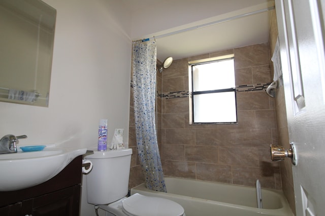 full bathroom with vanity, shower / bathtub combination with curtain, and toilet