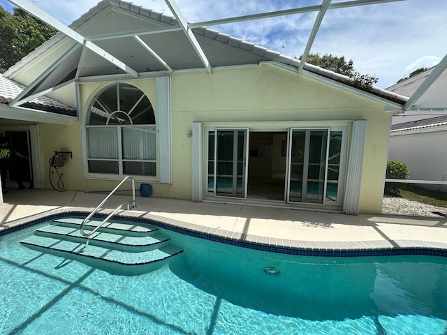 view of swimming pool with a patio and a lanai