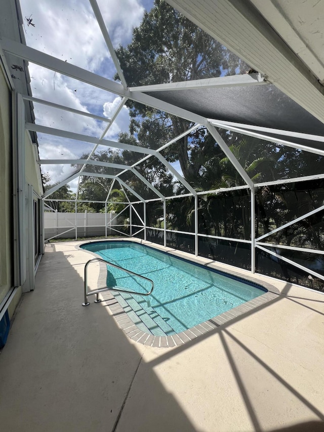 view of pool with a lanai and a patio