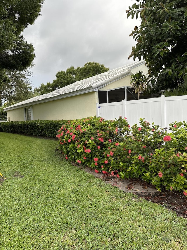 view of side of home featuring a lawn