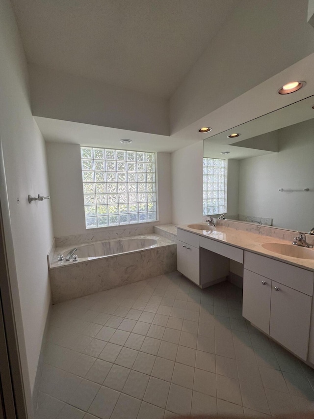 bathroom featuring vanity, tile patterned floors, and tiled bath