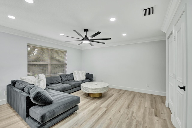 living room featuring ceiling fan, crown molding, and light hardwood / wood-style floors