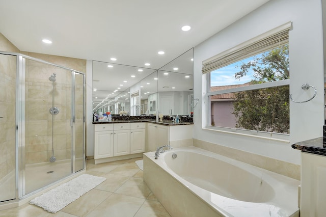 bathroom featuring shower with separate bathtub, tile patterned flooring, and vanity