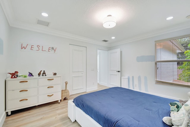 bedroom with light hardwood / wood-style floors and crown molding