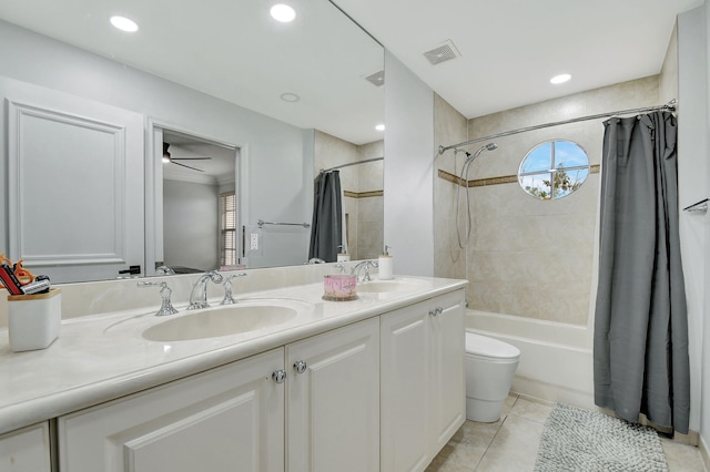 full bathroom with vanity, shower / bathtub combination with curtain, tile patterned flooring, ceiling fan, and toilet