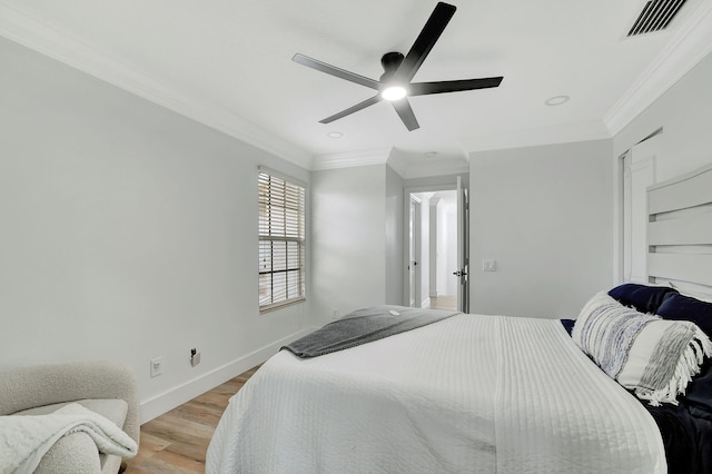 bedroom featuring ceiling fan, crown molding, and light wood-type flooring