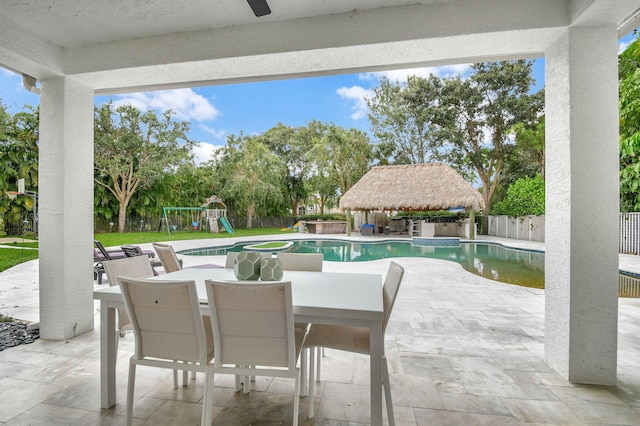 view of patio / terrace with a fenced in pool and a playground