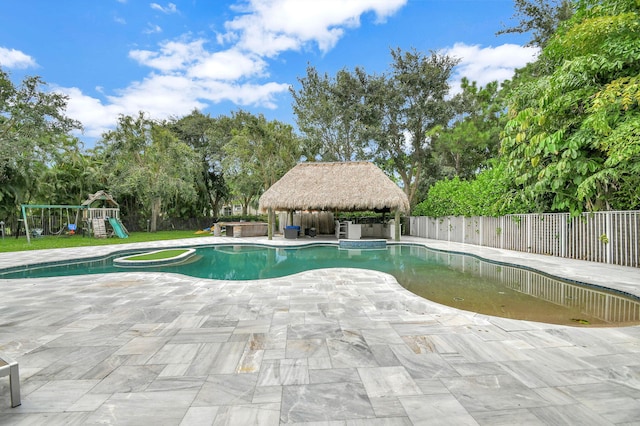 view of swimming pool featuring a gazebo, a playground, and a patio