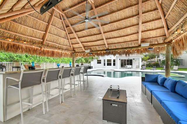 view of swimming pool featuring a gazebo, ceiling fan, an outdoor bar, and a patio area