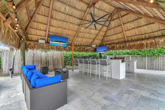 view of patio / terrace featuring ceiling fan, a gazebo, exterior bar, and an outdoor kitchen