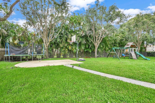 view of yard featuring a trampoline and a playground