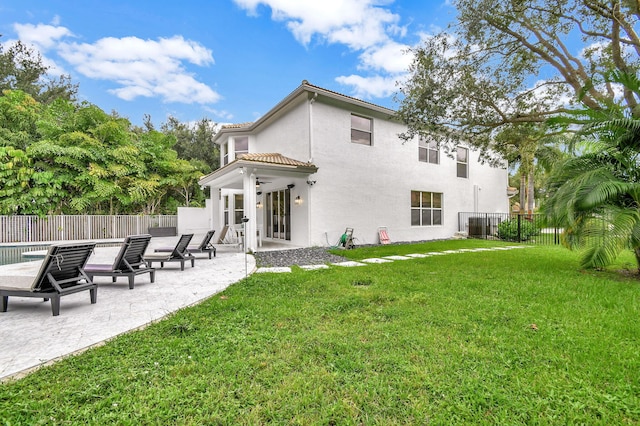 rear view of property with a patio area and a yard