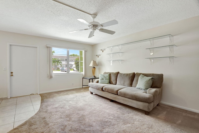 living room with a textured ceiling, light tile patterned flooring, and ceiling fan